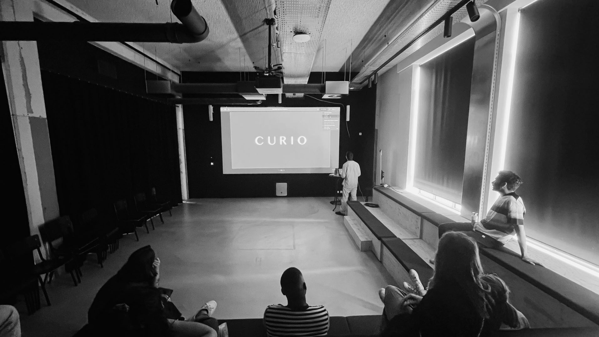 A presentation on a large screen in front of clients
